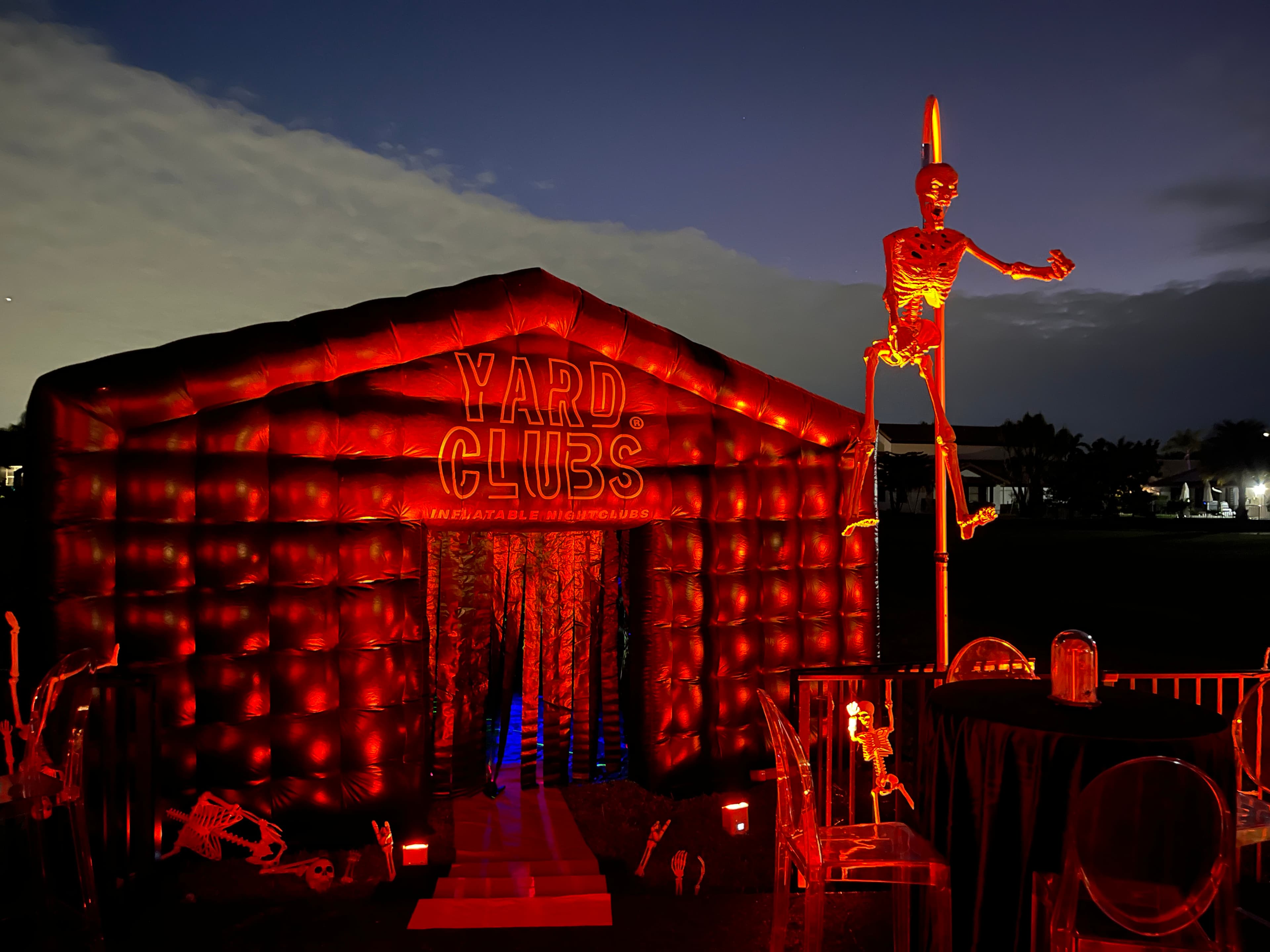 A Yard Clubs nightclub lit red at dusk for a Halloween party