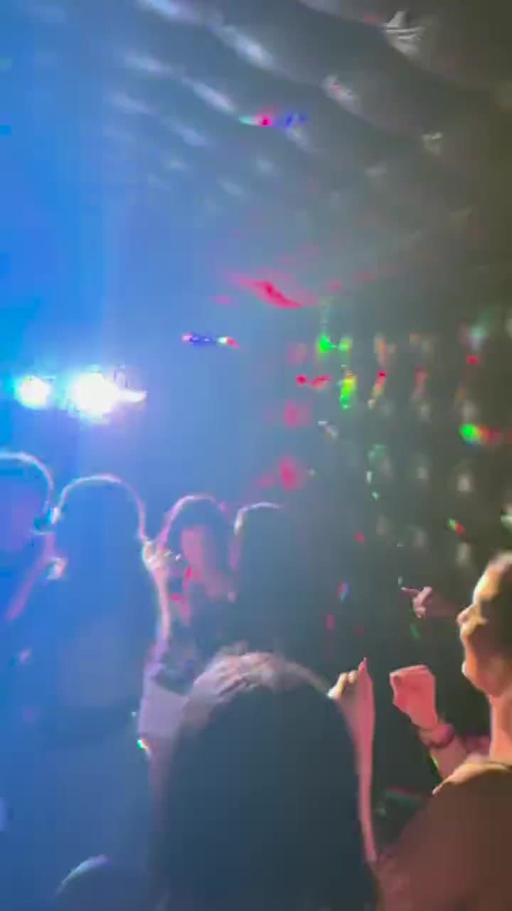 Inside a Yard Clubs nightclub during a party: guests dancing under colored club lights